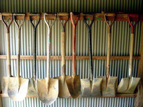 shovels hanging on wall