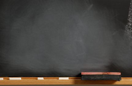 blank black board with chalk tray