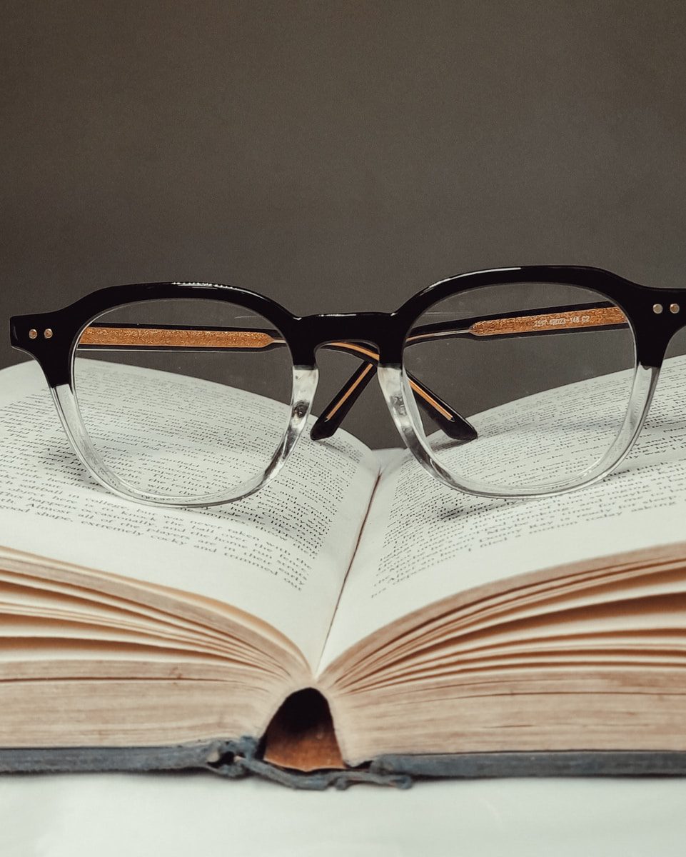 black framed eyeglasses on book page