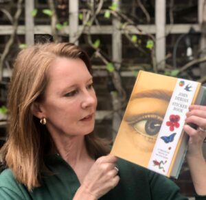 Gretchen holding a book of John Derian's Sticker book