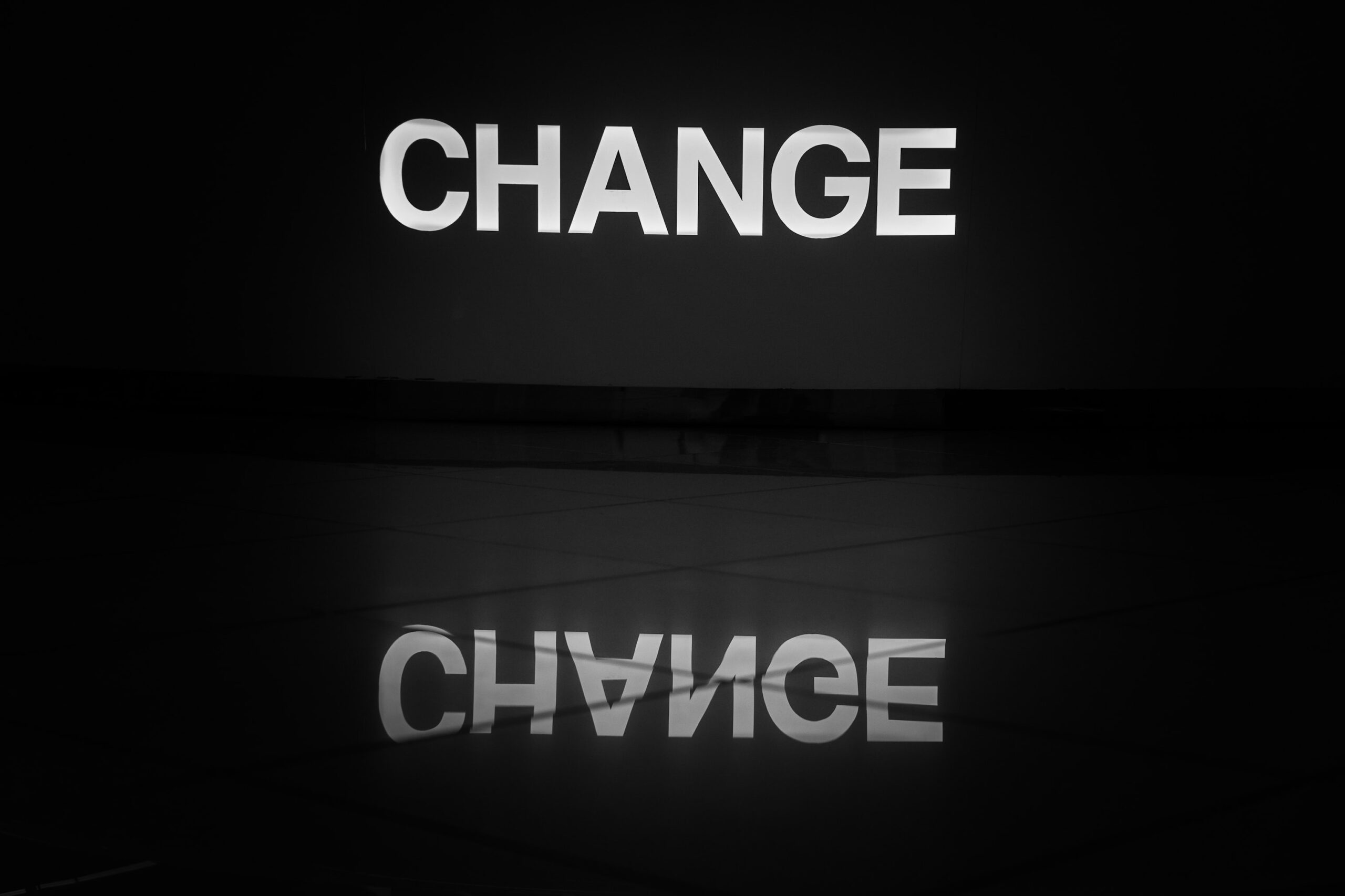 Photo of a sign that reads Change