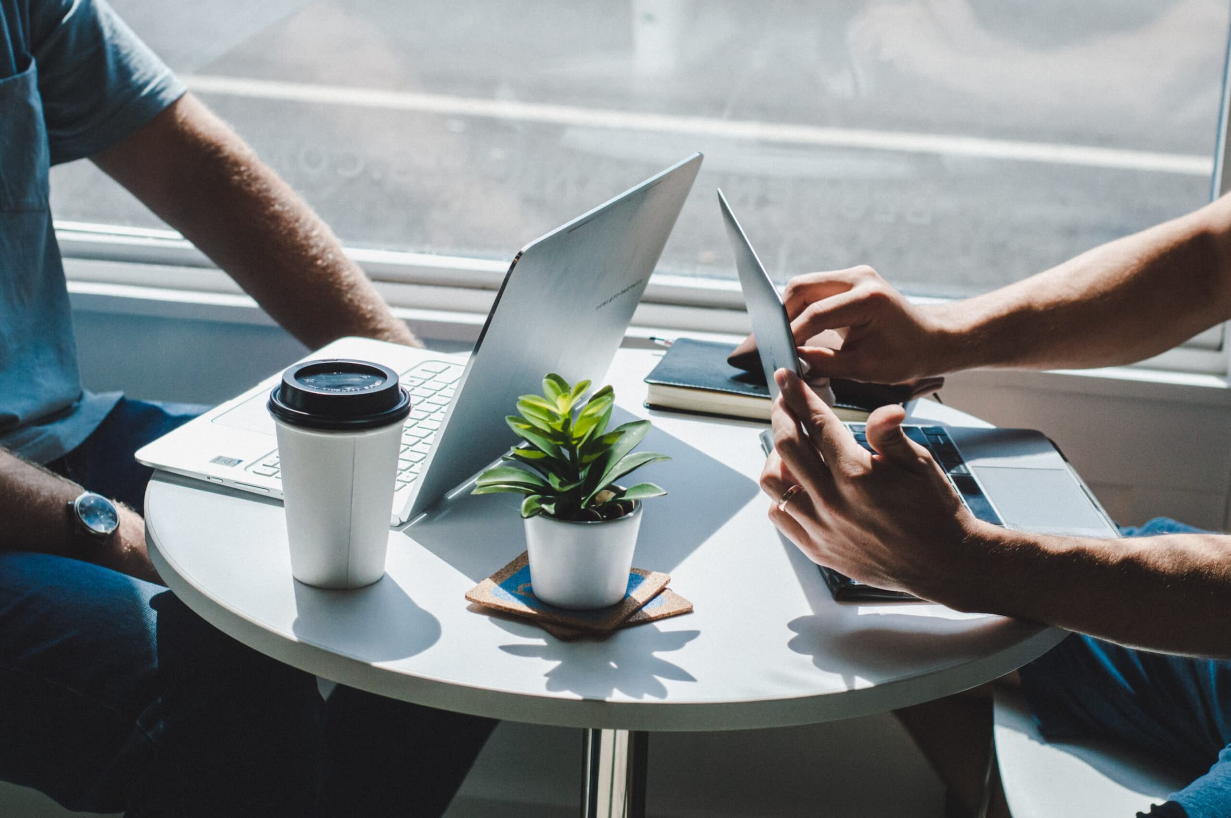 Photo of two people having a meeting with their laptops