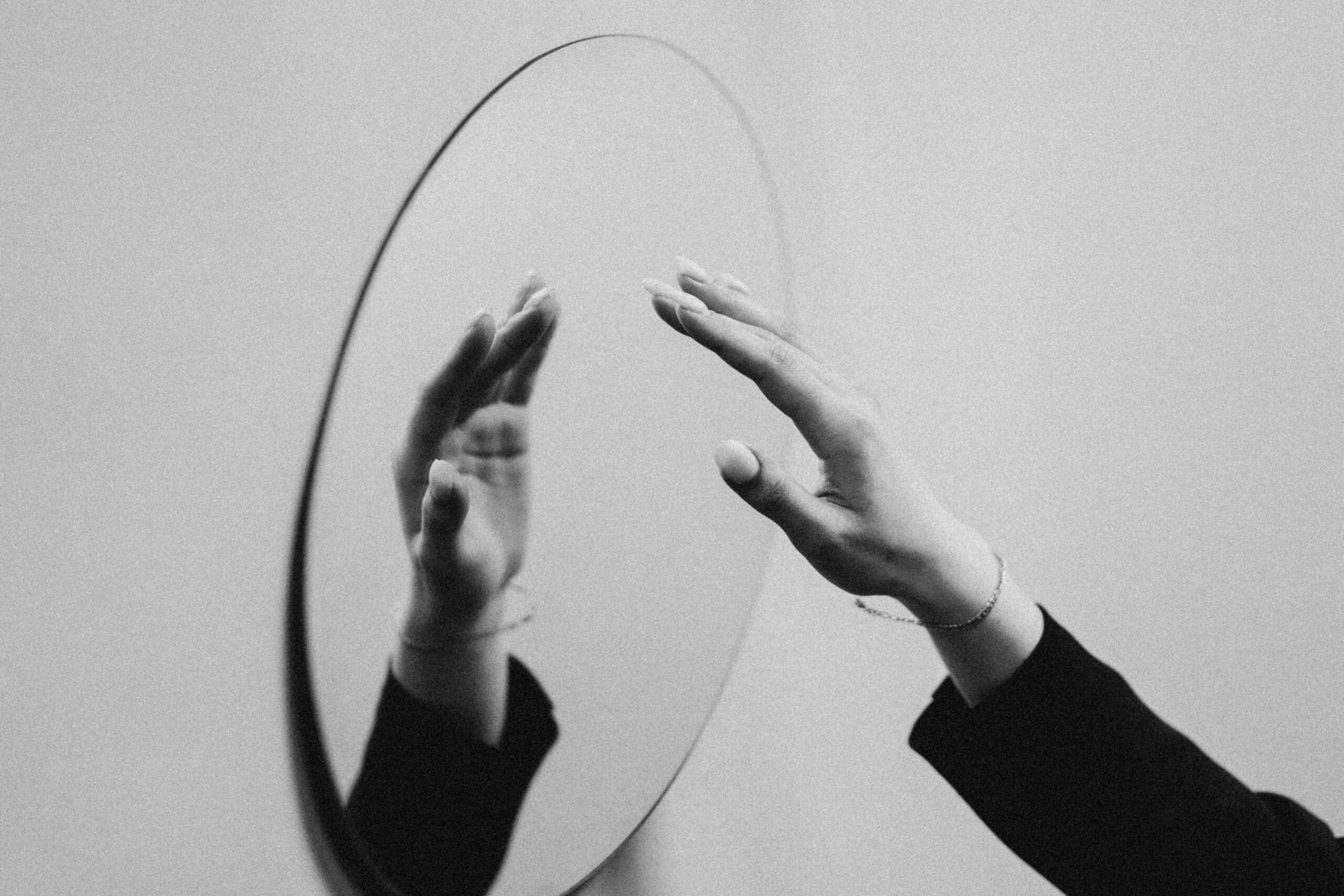 Photo of a mirror reflecting a person's hand