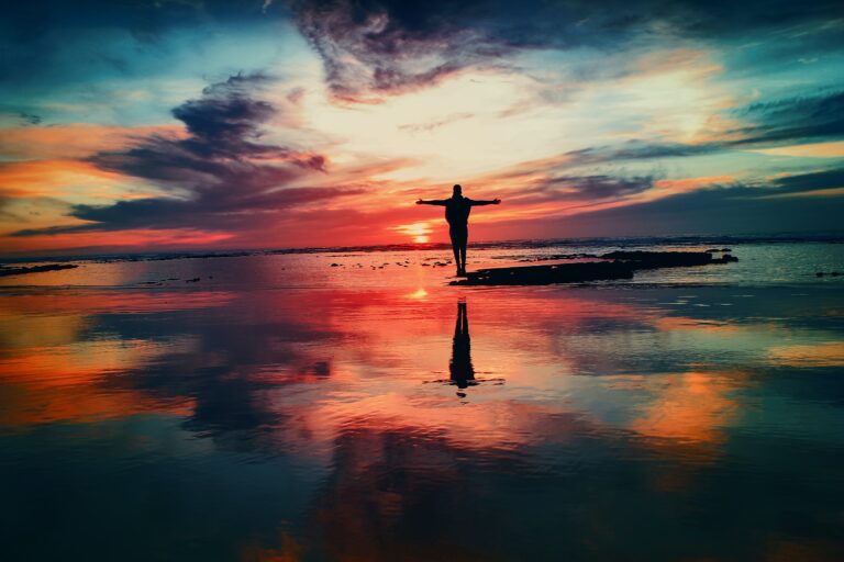 Photo of a person on a beach at sunset