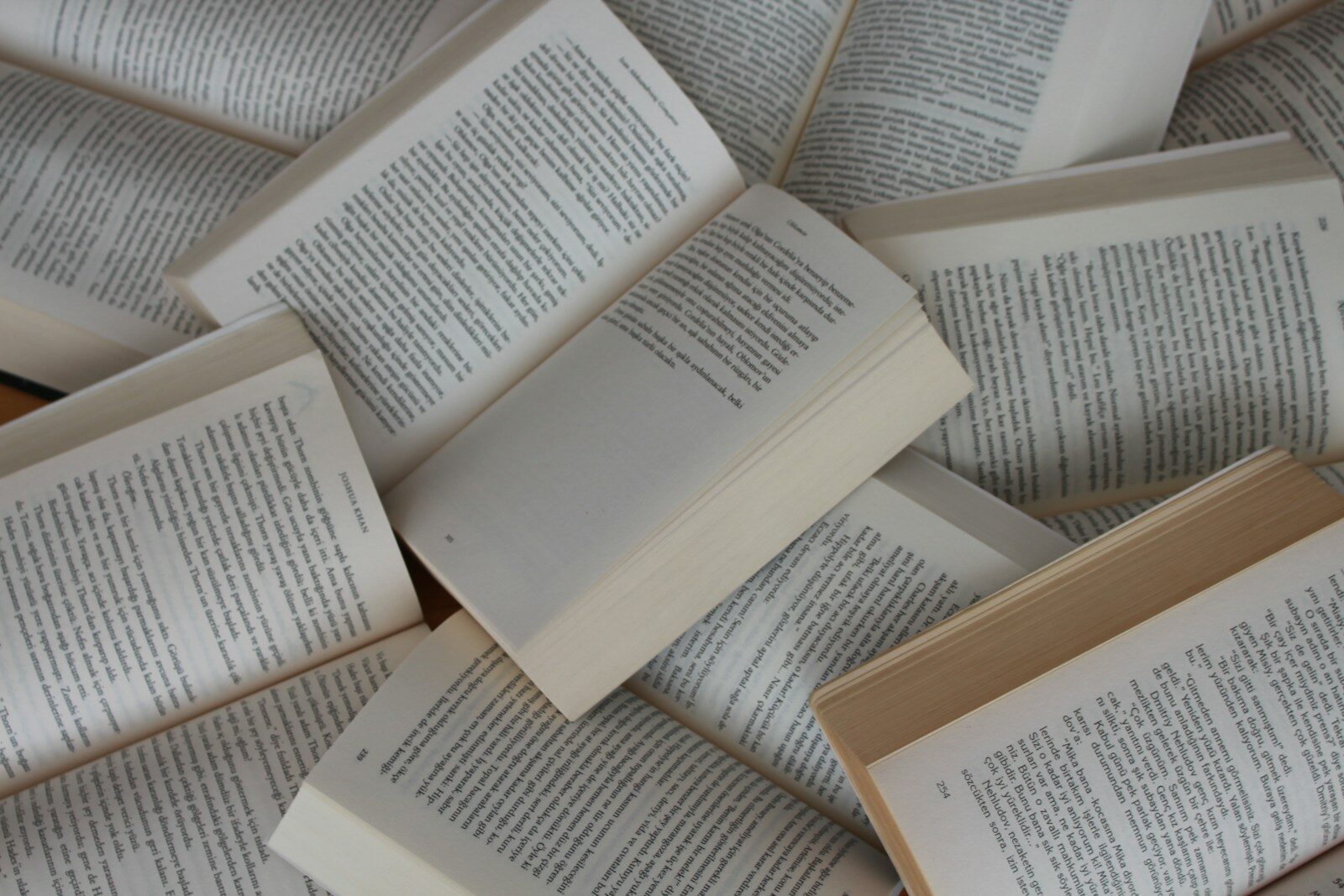pile of open paperback books