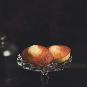 two baked breads placed on clear glass cupcake stand in focus photography