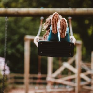 Child playing on a swing set